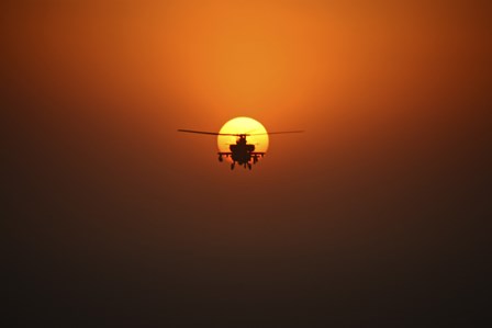 An AH-64D Apache Helicopter Flying into the Sun over Iraq by Terry Moore/Stocktrek Images art print