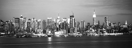 Skyscrapers lit up at night in a city, Manhattan, NY by Panoramic Images art print